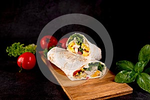 Tortilla wrapped with fried chicken meat, vegetables and corn