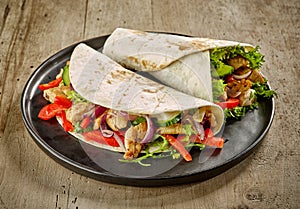 Tortilla wraps with fried chicken meat and vegetables