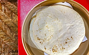 Tortillas in a bowl Plate on red table in Mexico