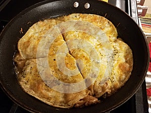 tortillas with cheese cooking in a frying pan on the stove