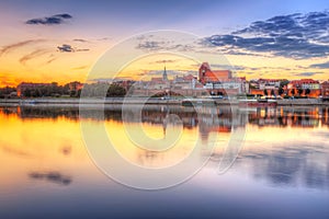 Torun old town reflected in Vistula river at sunset