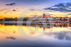 Torun old town reflected in Vistula river at sunset photo