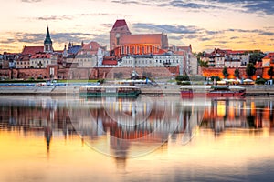 Torun old town reflected in Vistula river at sunset photo