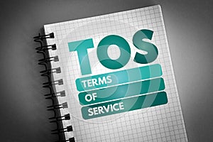 TOS - Terms Of Service acronym on notepad, concept background