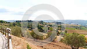 Toskana landscape: vineyards, olive trees and small village photo
