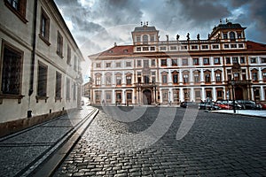 Toskansky Palace at Hradcany Square in Prague, Czech Republic with sunset light and sun flares