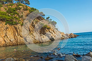 TOSSA DE MAR, CATALONIA, SPAIN: A beautiful small beach between the mountains with rocks near the fortress