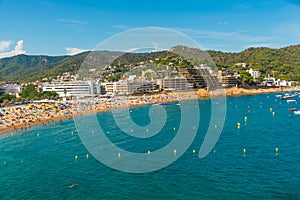 TOSSA DE MAR, CATALONIA, SPAIN: People enjoy the sun as they lay on the beach at Tossa de Mar.