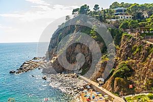 TOSSA DE MAR, CATALONIA, SPAIN: People enjoy the sun as they lay on the beach at Tossa de Mar.