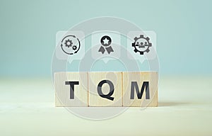 Total quality management TQM concept, TQM on wooden cubes with symbols on smart background, copy space. Management approach to l