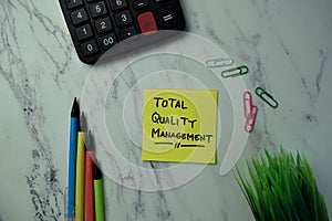Total Quality Management write on sticky notes isolated on office desk