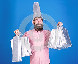 Total sale concept. Man bearded hipster with lot shopping bags. Could not resist discount. Shopping on black friday