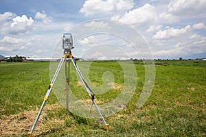 total station in the field survey equipment in a green land being measured