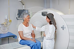 This is a totally noninvasive procedure. Shot of a senior woman being comforted by a doctor before and MRI scan.
