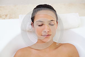 Totally relaxed at the beauty spa. a beautiful young woman relaxing in the bathtub.