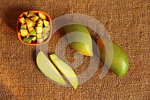 Raw totapuri mangoes, bowl full with sliced pieces applied with salt and chili powder photo