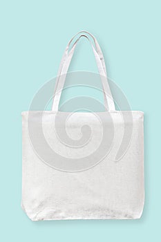 Tote bag canvas white cotton fabric cloth for eco shoulder shopping sack mockup blank template isolated on pastel blue background