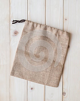 Tote bag with drawstring mockup of small eco sack made from jute hessian canvas or natural hemp burlap flat lay