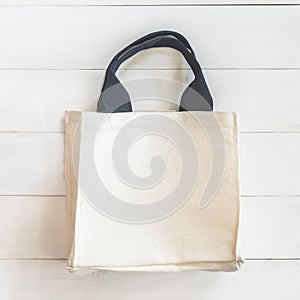 Tote bag fabric cloth shopping sack mockup  on white wood background