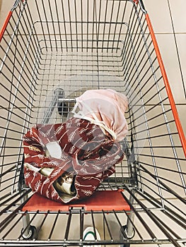Tote bag with food and eco reusable cotton bags with vegetables and fruits in cart in supermarket. Zero waste shopping concept.