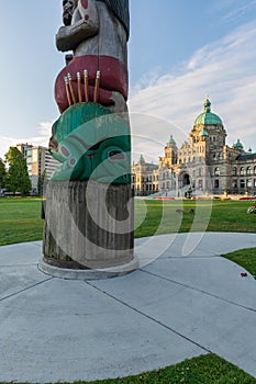 Totem Pole and the Legislative Assembly in Victoria, British Columnbia photo