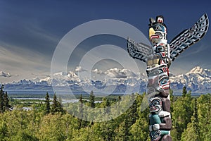 A totem wood pole in mountain background