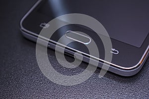 Touch phone black on black background.