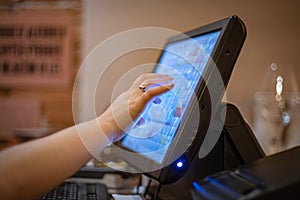 A touch-screen cash register system in the restaurant to book a table, add items and pay by card or cash