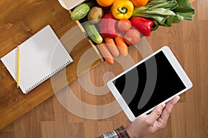 Touch screen digital tablet, fresh vegetables