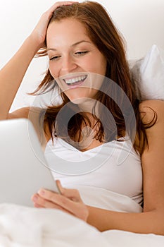 Touch screen tablet computer - woman in bed