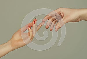 Touch of two hands. Man and woman hand about to touch with index finger. Couple in love reaching to each other. Hand try