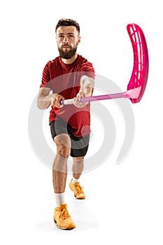 Portrait of young man, floorball player with floorball stick isolated on white background. Sport, competition and motion photo