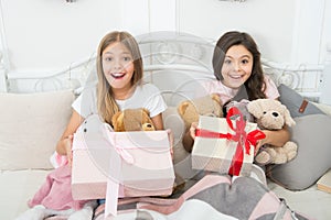 So touched with gift. Small girls bed on Christmas eve. Happy children Christmas spirit. Small children in bedroom with