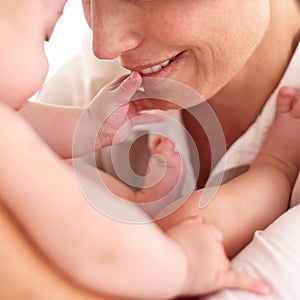 Touching the face of motherly love. Cropped image of a baby touching its mothers face.