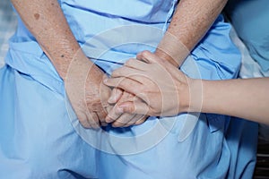 Touching hands Asian senior or elderly old lady woman patient with love