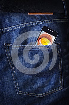 Touchscreen smartphone/cellphone in jeans poket photo