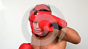Tough boxer punching with red gloves