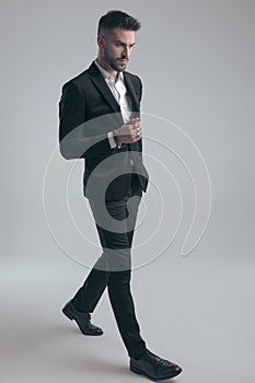 Tough elegant man wearing suit and walking