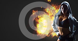 Tough fit woman with burning fire flames