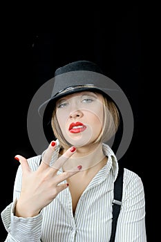 Tough girl in hat shows fingers