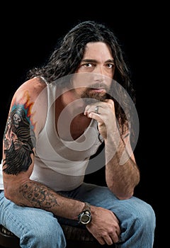 Tough man with long dark hair and beautiful brown eyes