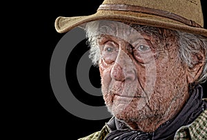 Tough old rancher isolated on black