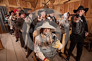 Tough People with Guns in Old Saloon