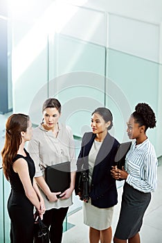 Tough problems are no match for tough teams. businesswoman standing together while discussing business in the office.