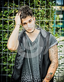 Tough young man in dark t-shirt outdoor