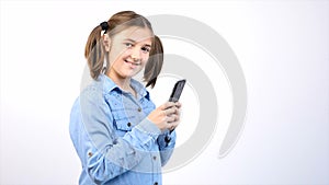 Toung pretty girl child using smartphone on gray background