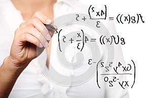Toung teacher solving a mathematical equation photo