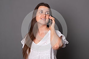 Toung woman emotionally talking on a mobile phone. Happy young woman