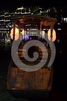 A tour boat docks along the Tuo Jiang River in Fenghuang Ancient City, a favorite attraction in Tibet, China