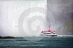 Tour boat in the mist under Horseshoe Falls on the Niagara River